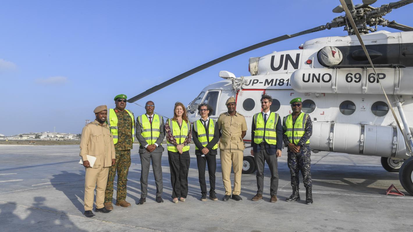 staff pose in front of helicopter
