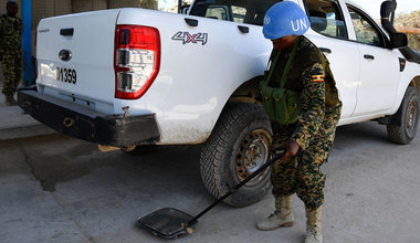 UN Photo/Ilyas Ahmed A female Ugandan soldier serving under the United Nations Guard Unit (UNGU) in Somalia, searches a vehicles at a checkpoint in Mogadishu.